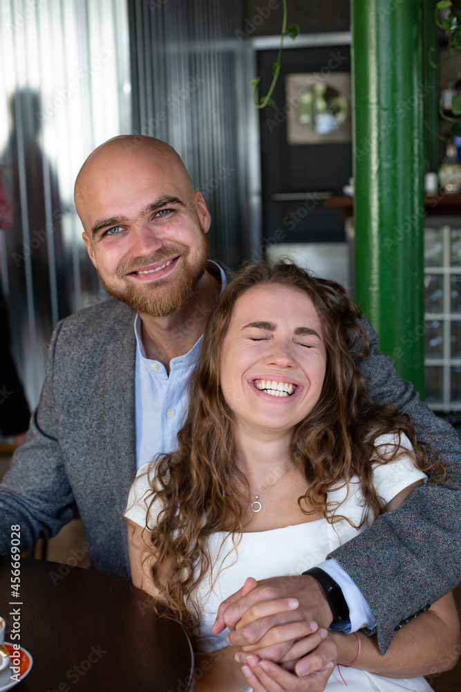 Happy white young married couple sitting in the restaurant Happy white young married couple sitting in the restaurant