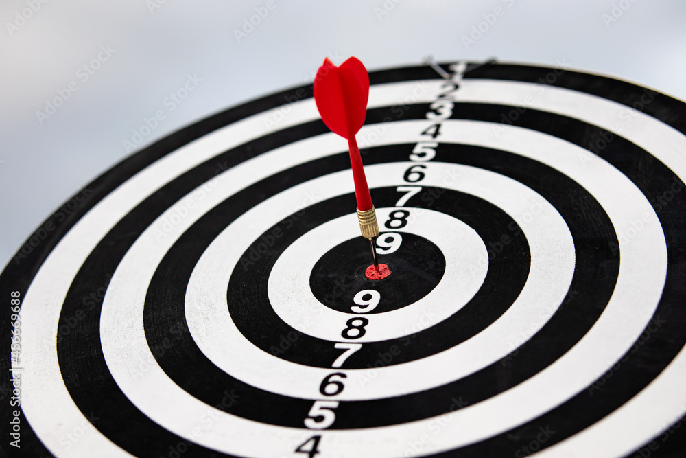 dart arrow hitting in the bullseye center of dartboard. concept of business targeting and aim for business success dart arrow hitting in the bullseye center of dartboard. concept of business targeting and aim for business success