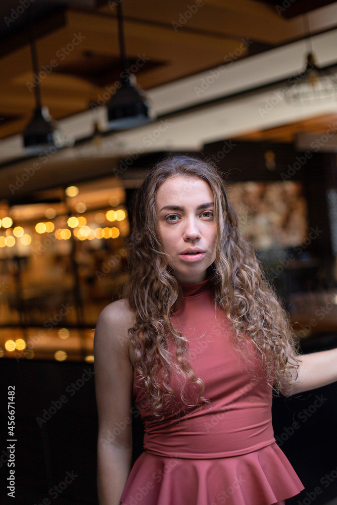 European girl with dark and curly hair in the restaurant European girl with dark and curly hair in the restaurant