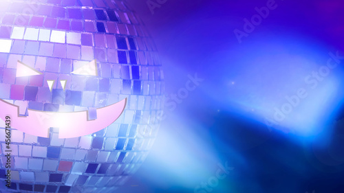 mirror ball with halluin face on colored background with highlights photo