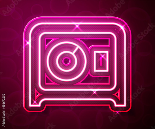 Glowing neon line Safe icon isolated on red background. The door safe a bank vault with a combination lock. Reliable Data Protection. Vector
