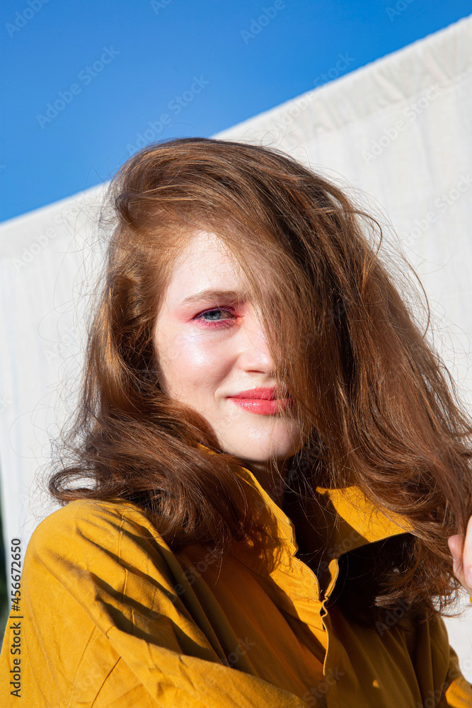 White european young girl with bright makeup with sky behind White european young girl with bright makeup with sky behind