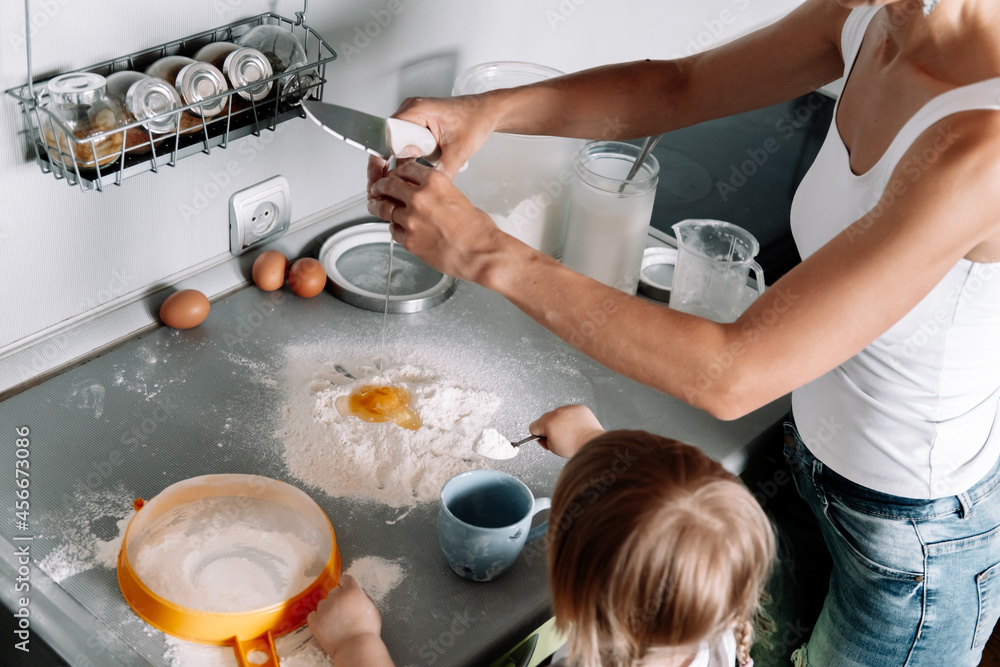 Top view table with hands of mother and little daughter preparing dough for ginger cookies on kitchen. Happy family, cozy apartments. Top view table with hands of mother and little daughter preparing dough for ginger cookies on kitchen. Happy family, cozy apartments.