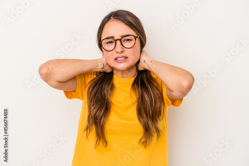 Young caucasian woman isolated on white background touching back of head, thinking and making a choice.