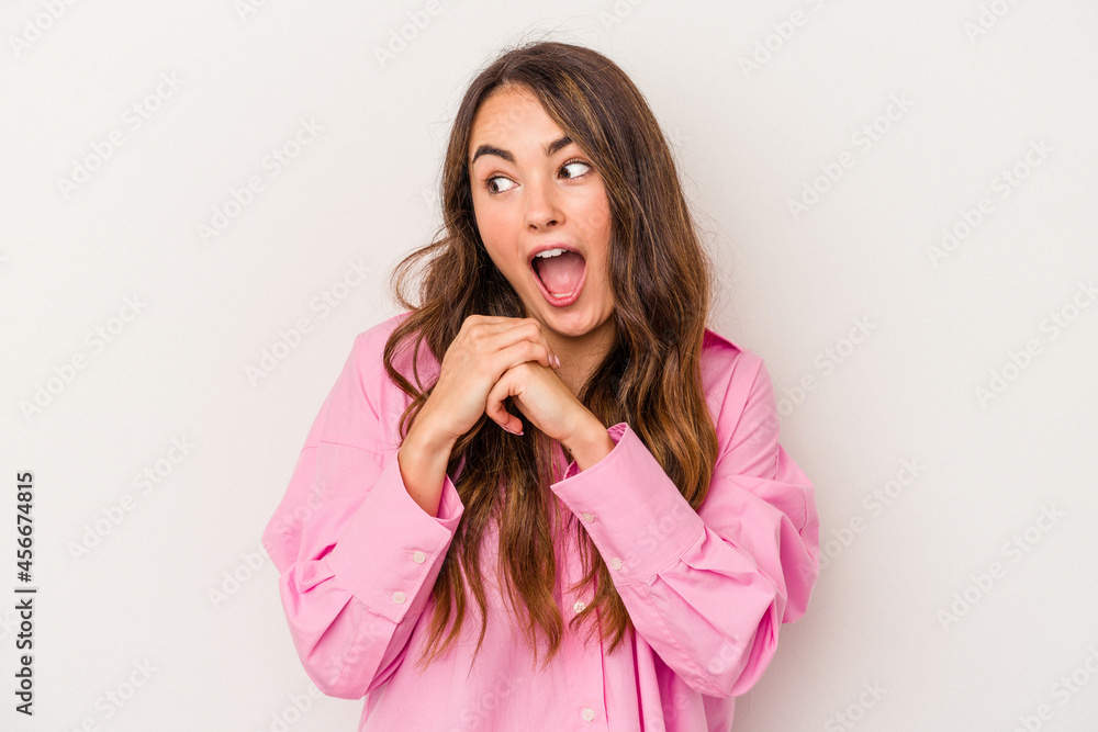Young caucasian woman isolated on white background praying for luck, amazed and opening mouth looking to front. Young caucasian woman isolated on white background praying for luck, amazed and opening mouth looking to front.