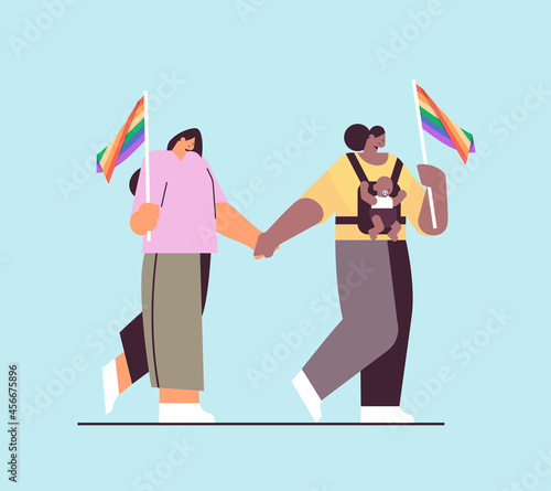 mix race female parents walking with little child lesbian family transgender love LGBT community concept