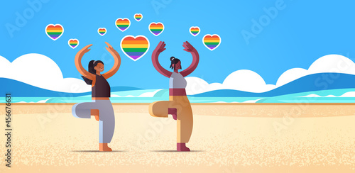 mix race girls lovers doing physical exercises beach lesbian love parade transgender LGBT concept