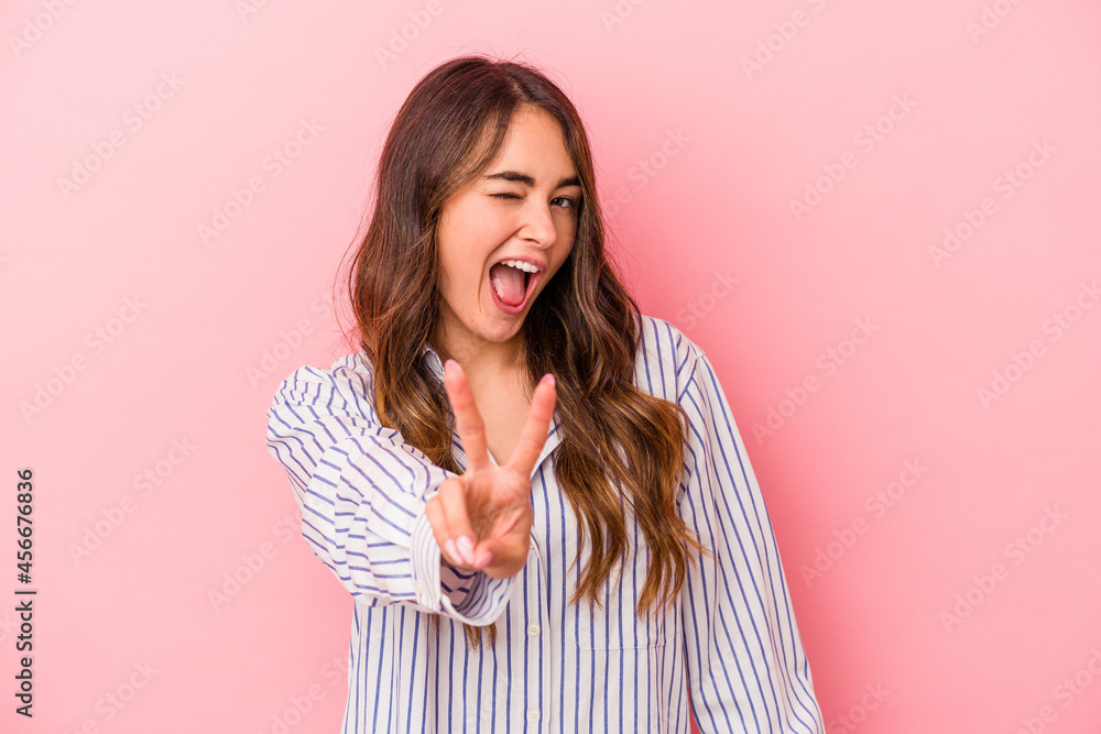 Young caucasian woman isolated on pink background showing number two with fingers. Young caucasian woman isolated on pink background showing number two with fingers.