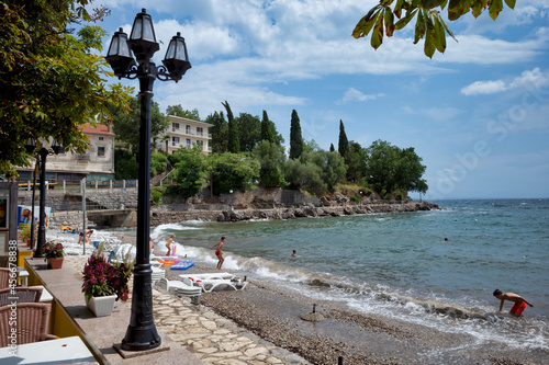 Rijeka, Croatia - August 11, 2021: Resort on the Adriatic Sea. City beaches, vegetation and buildings in Croatia. Seascape with a stone shore.