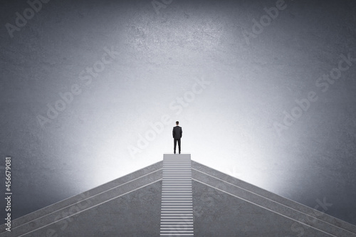 Back view of businessman on top of stairs with mock up place on concrete background. Career growth and success concept.