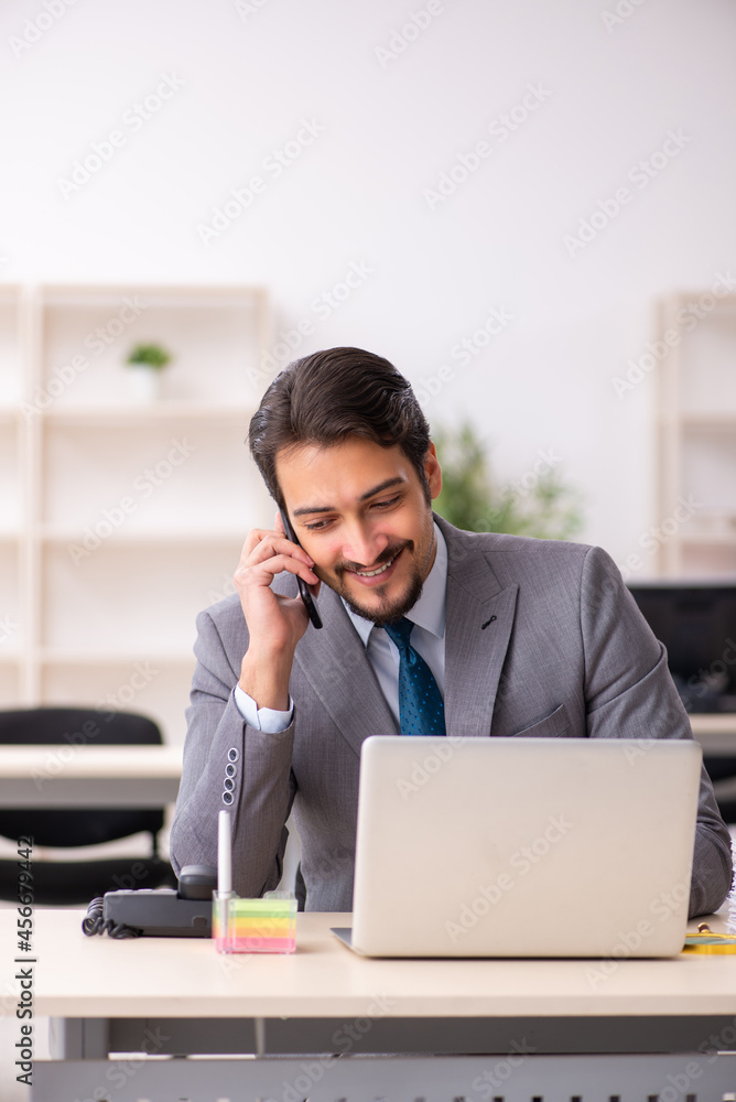 Young male employee working in the office Young male employee working in the office