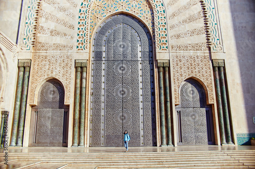 Beautiful girl on the background of the Hassan II mosque in Casablanca Morocco