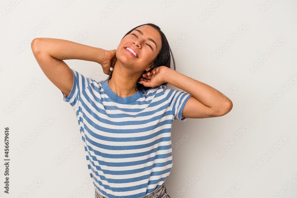 Young latin woman isolated on white background feeling confident, with hands behind the head. Young latin woman isolated on white background feeling confident, with hands behind the head.