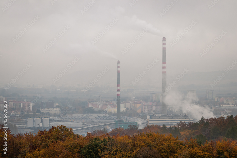 Smog and air pollution over city at fall season. Coal power plant with chimney emission. Environmental damage and issues Smog and air pollution over city at fall season. Coal power plant with chimney emission. Environmental damage and issues