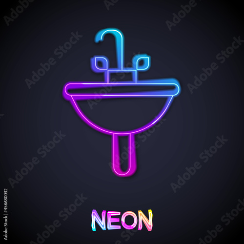 Glowing neon line Washbasin with water tap icon isolated on black background. Vector