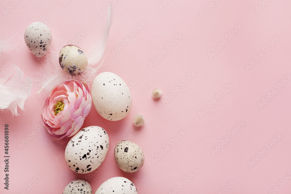 quail easter eggs and spring flowers on pink background