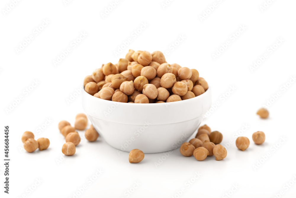 Raw chickpeas in white bowl isolated on white Raw chickpeas in white bowl isolated on white