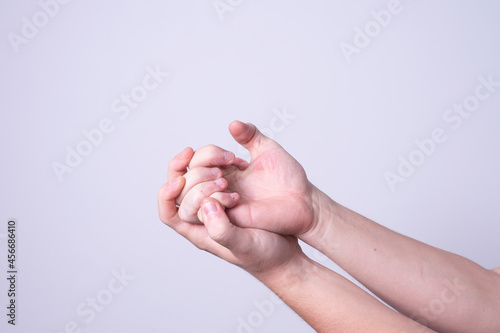 a man massages his hands from chilling pain
