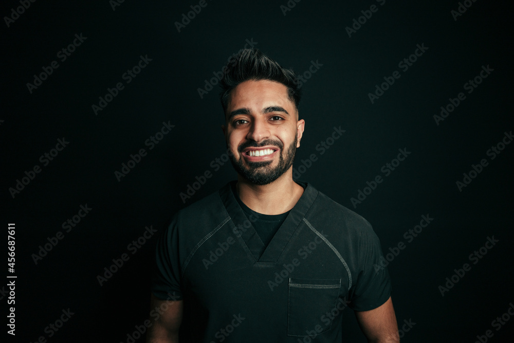 Mixed race male dentist smiling big at camera for portfolio shoot Mixed race male dentist smiling big at camera for portfolio shoot