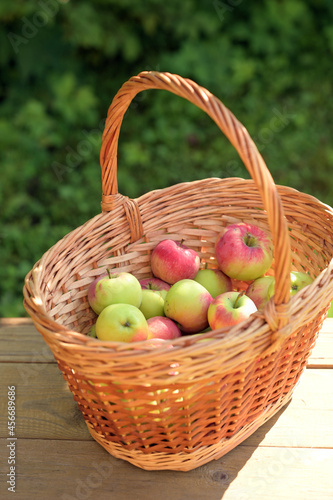 Ripe apples in a wicker basket. An image with a selective focus.