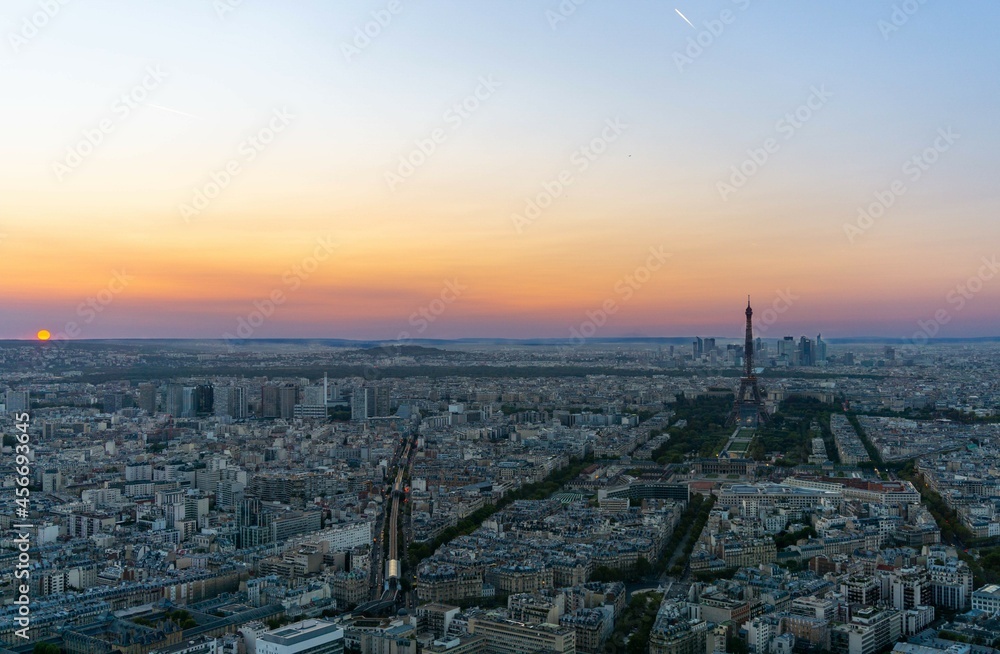 Skyline of Paris, at dusk with the sun on the side of the image, photo with the sunset of various colors