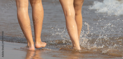 Feet of a girl and a man in the water