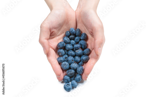 Bluepberry kept in hands isolated on white background.