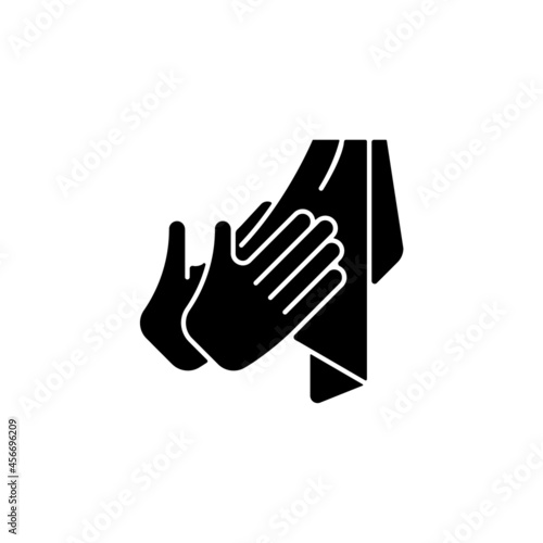 Dry hands with towel black glyph icon. Effective bacteria removing. Using paper and textile towels. Reducing covid transmission. Silhouette symbol on white space. Vector isolated illustration
