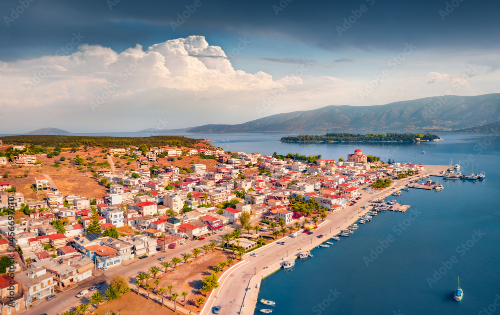 Impressive summer cityscape of Kilada port. Wonderful morning scene of Peloponnese peninsula, Greece, Europe. Attractive seascape of Mediterranean sea. View from flying drone.