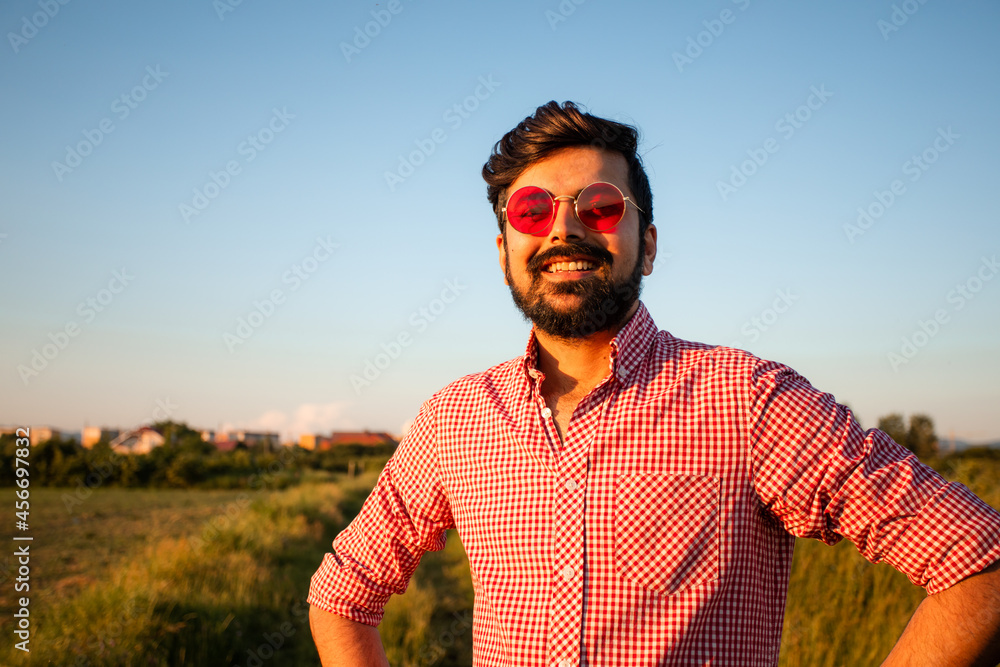 Man in pink glasses enjoying sunny weather Man in pink glasses enjoying sunny weather