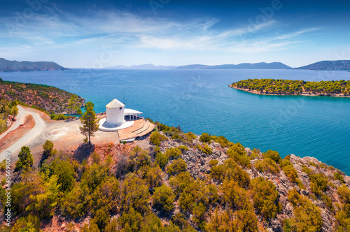 Fantastic summer view of old windmill in outskirts of Ermioni  town. Astonishing morning seascape of Mediterranean sea. Spectacular outdoor scene of Peloponnese peninsula, Greece, Europe. photo