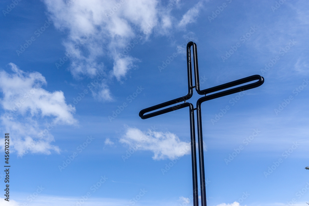 Cross in the mountains in sunny weather