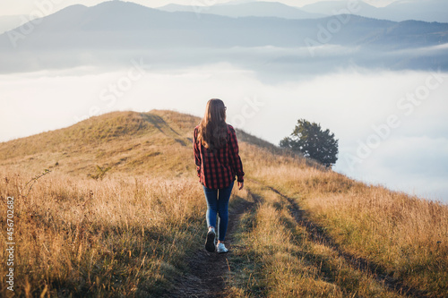 Young Girl Walking in Foggy Mountain Landscape