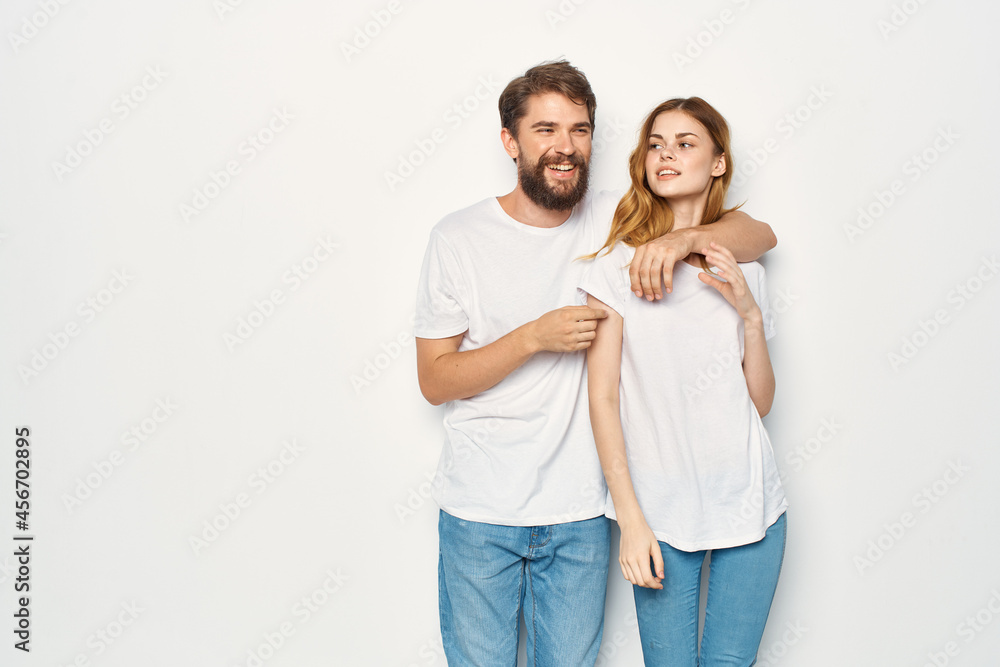 man and woman in white t-shirts are standing next to family light background man and woman in white t-shirts are standing next to family light background