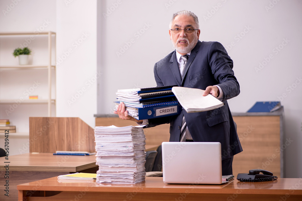 Old male employee and too much work in the office Old male employee and too much work in the office