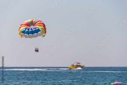 Turkey, Alanya, Side, 27.08.2021: Extreme entertainment, tourists on a parachute climb on a rope from a boat, ride a parachute on a rope over the sea