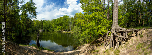 A small lake in the middle of the summer forest photo