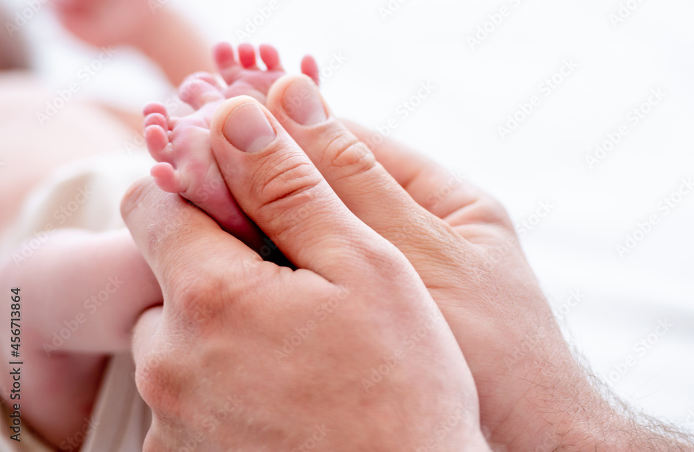 Mother holding newborn baby feet Mother holding newborn baby feet