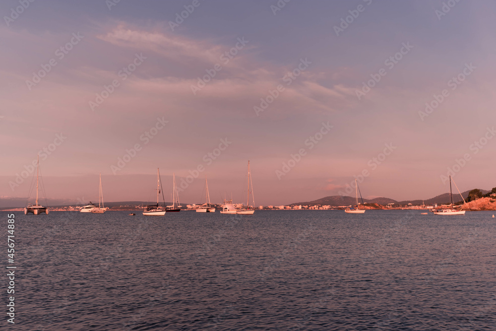 Fototapeta premium Sunset between boats and yachts on Illetes beach in Majorca, Balearic Islands, Spain