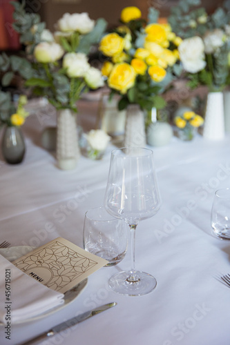 Table set with yellow roses for a festive party
