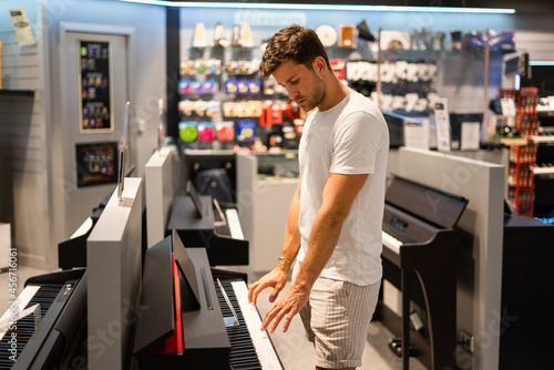 Customer testing electronic piano in store