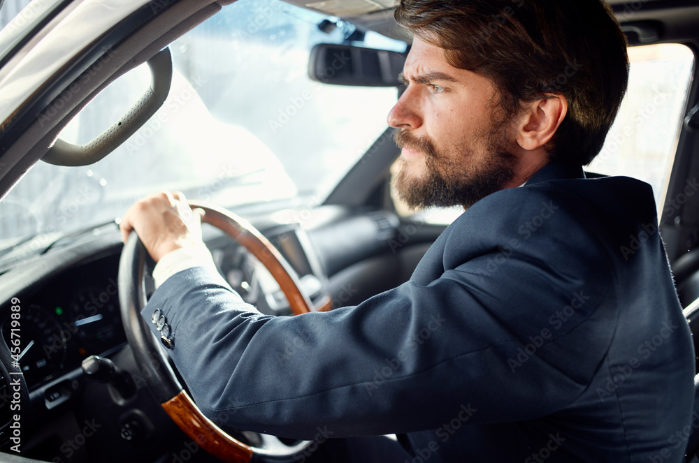 bearded man Driving a car trip luxury lifestyle rich