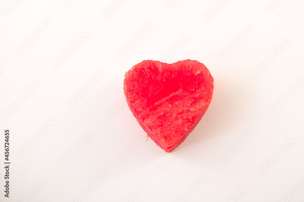 watermelon cut in heart shape isolated on white background, top view with copy space