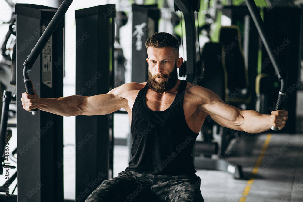 Handsome man bodybuilder doing workout at gym Handsome man bodybuilder doing workout at gym
