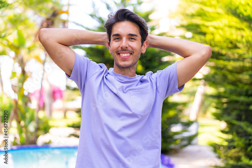 Young caucasian man at outdoors With happy expression