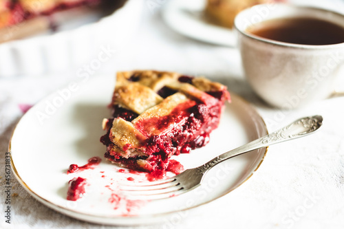 Fototapeta Naklejka Na Ścianę i Meble -  Piece of classic raspberry pie on plate with fork.