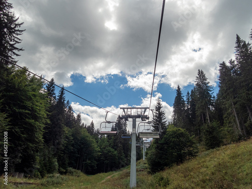 Ski-lift and evergreen trees in the mountain