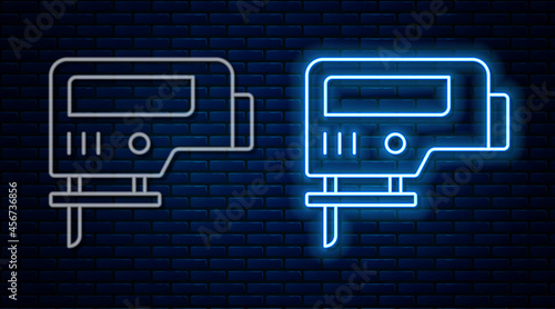 Glowing neon line Electric jigsaw with steel sharp blade icon isolated on brick wall background. Power tool for woodwork. Vector