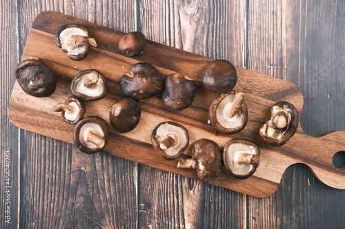 raw champignon mushroom on a chopping board on table 