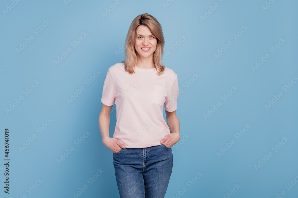 Portrait of stunning adorable girl look camera white smile on blue background Portrait of stunning adorable girl look camera white smile on blue background
